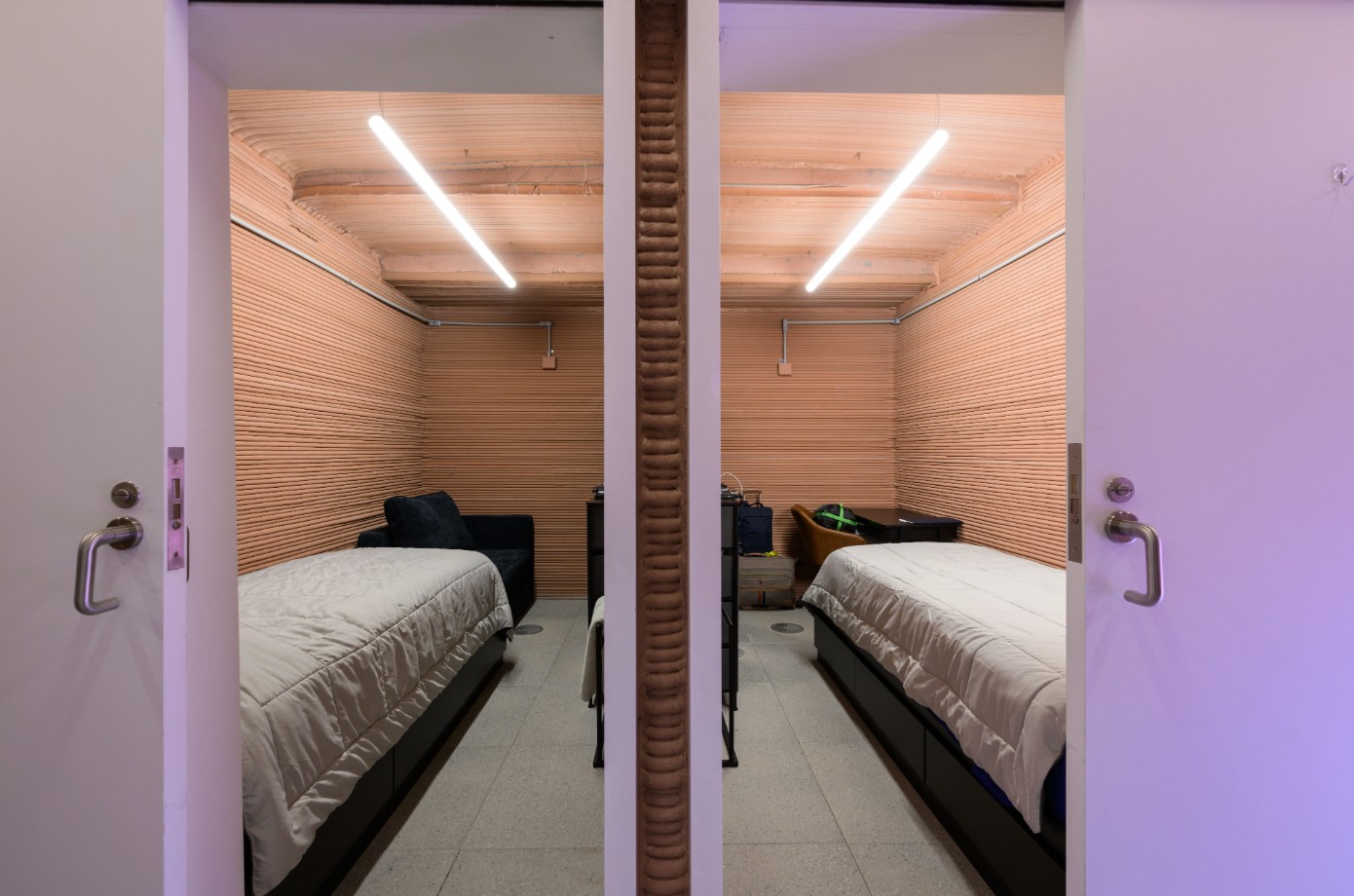 A picture of two very basic rooms each with a single bed, a chair and a little desk. 